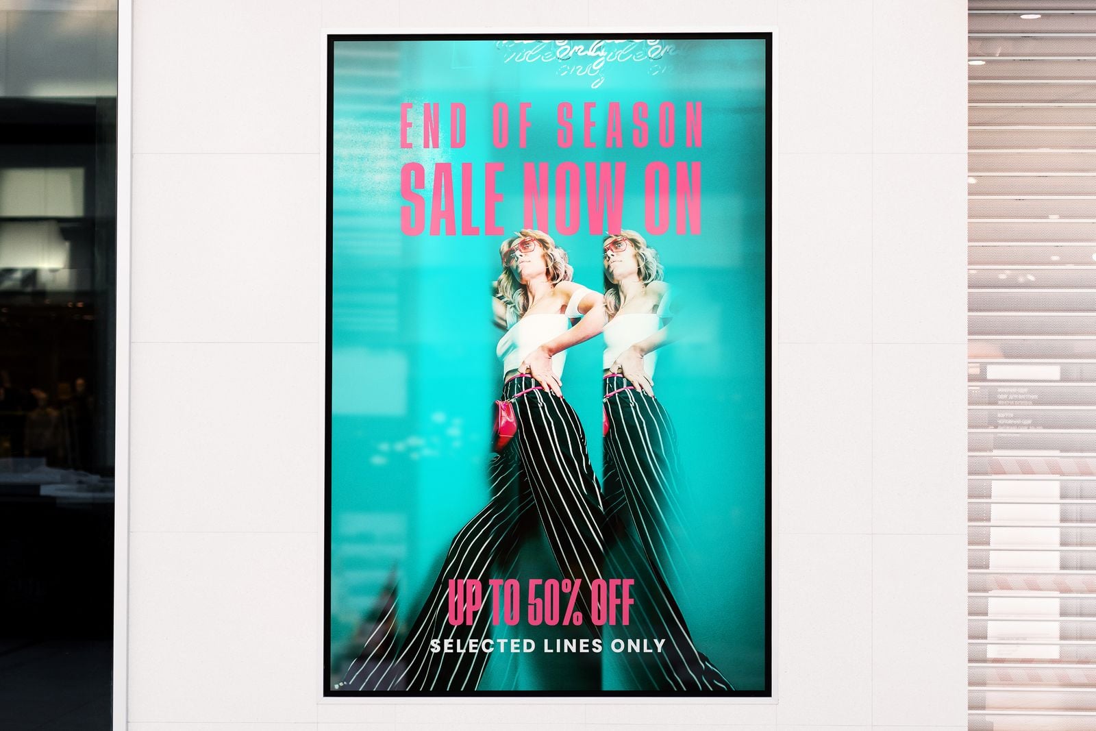 Backlit “End of season sale” poster in a lightbox on a shopfront
