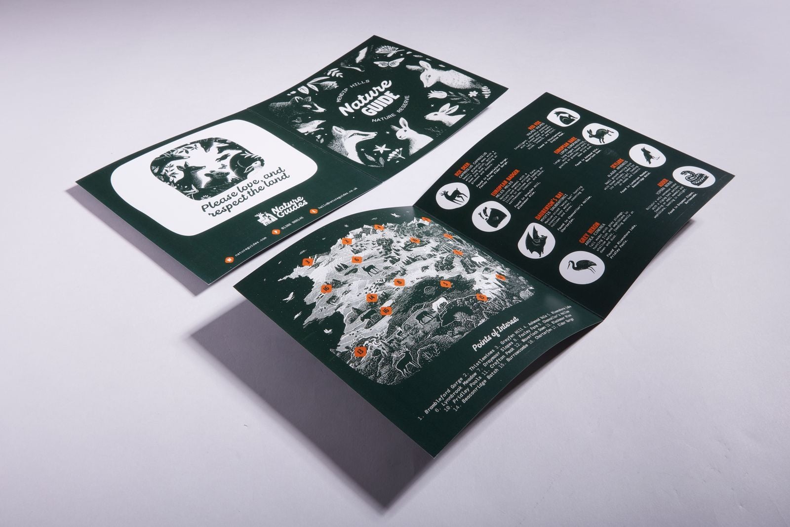Two square folded nature guides, one showing the back cover and one opened to the map inside