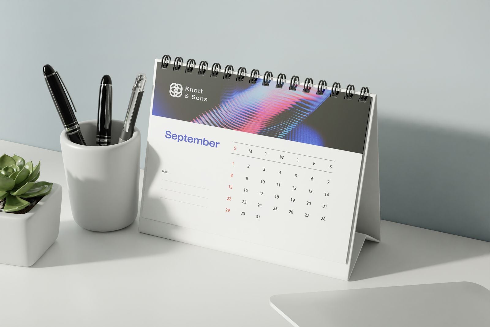 September desk calendar on its stand next to a pen pot