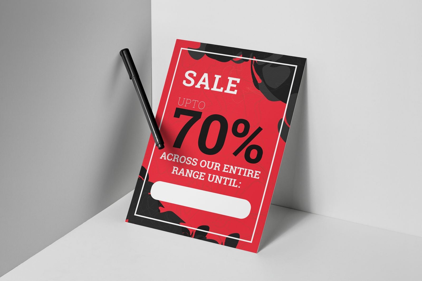 Red sale display board leaning in a corner with a marker pen
