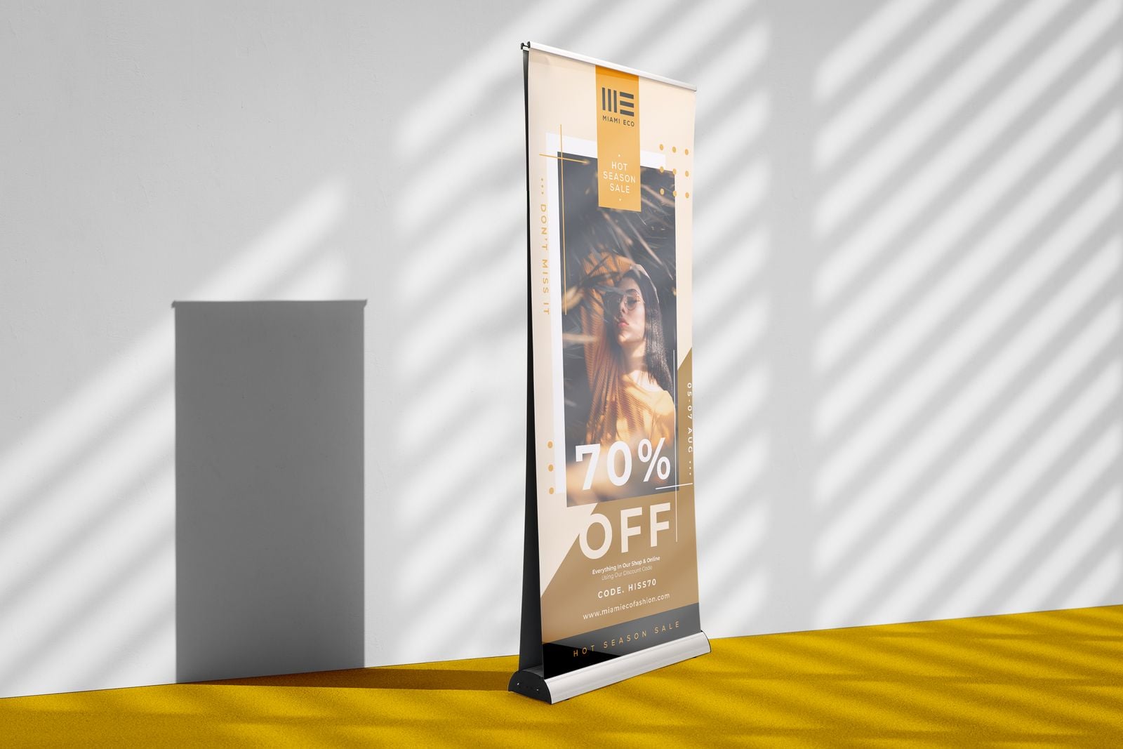 Double-sided roller banner advertising 70% off against a sunlit wall