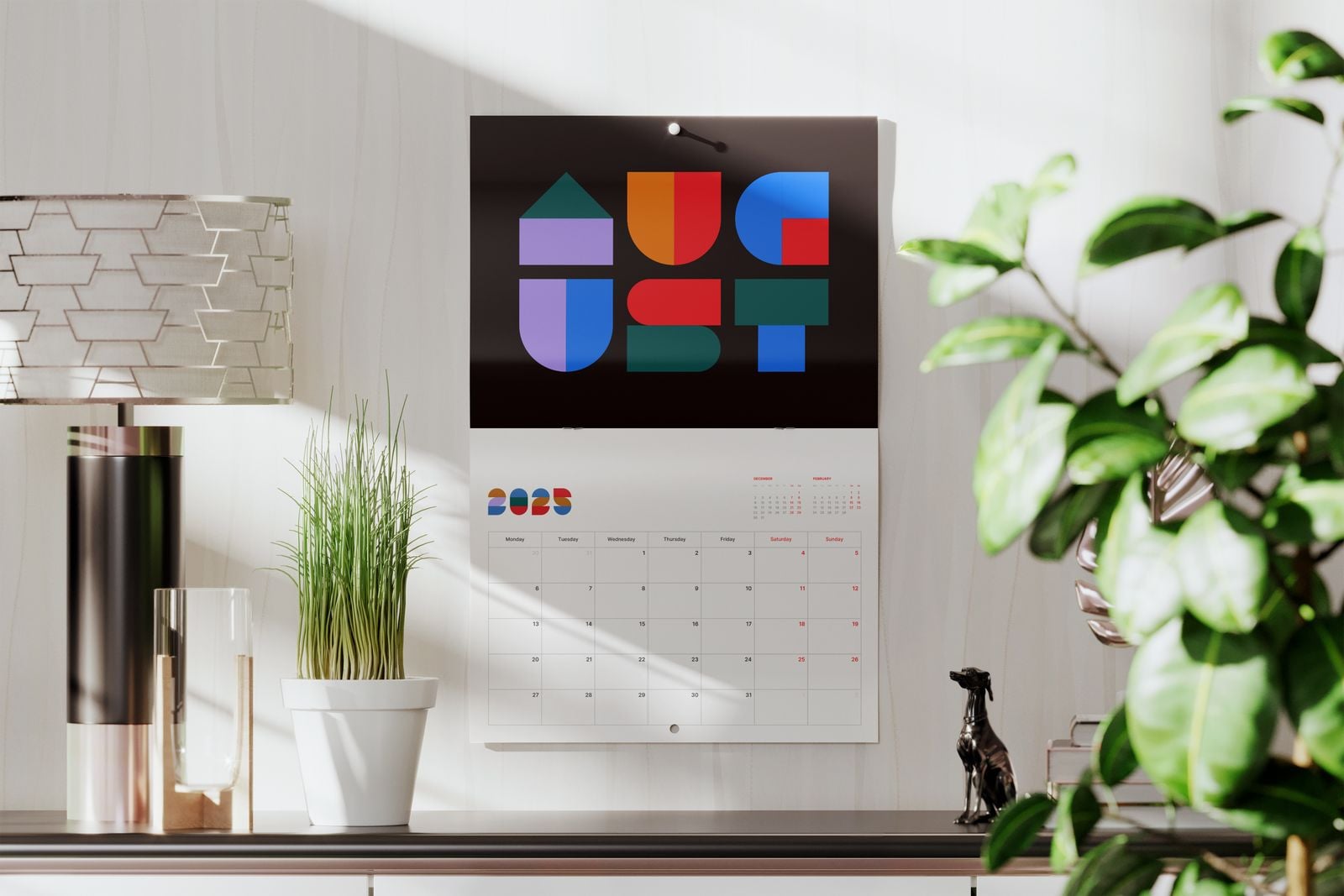 Drilled hole calendar with a colourful geometric picture hanging on a wall