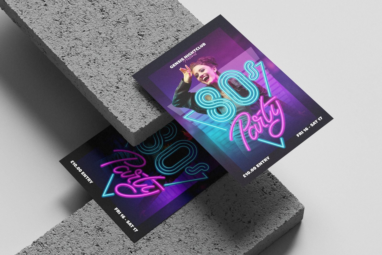 Two neon 80s party flyers printed on silk, propped against a concrete block