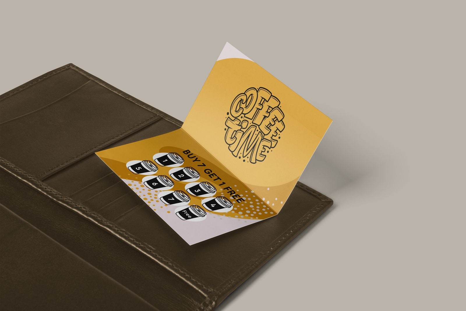 Yellow folded coffee loyalty card with “Buy 7 get 1 free” cup stamps, open on a leather wallet