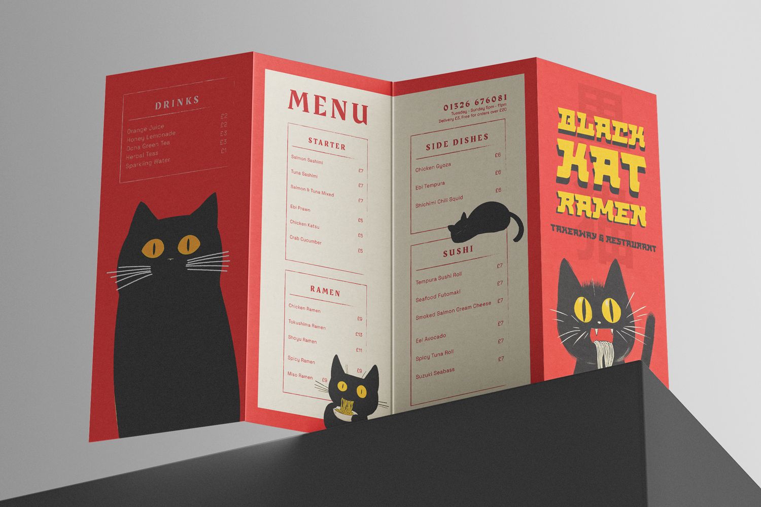 Red ramen menu printed as a concertina-folded DL leaflet, standing open on a black block