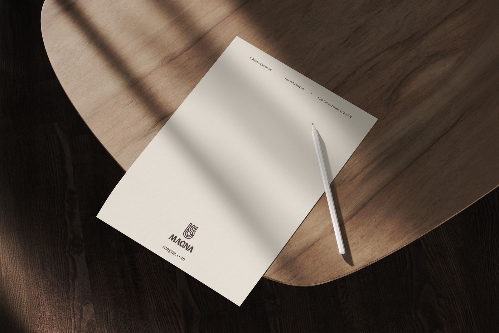 Cream letterhead with a pencil on a dark wooden table