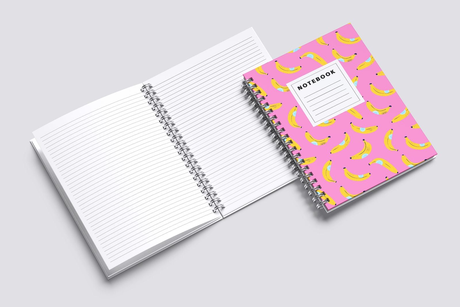 Wiro notebook with a pink banana cover beside another open at lined pages