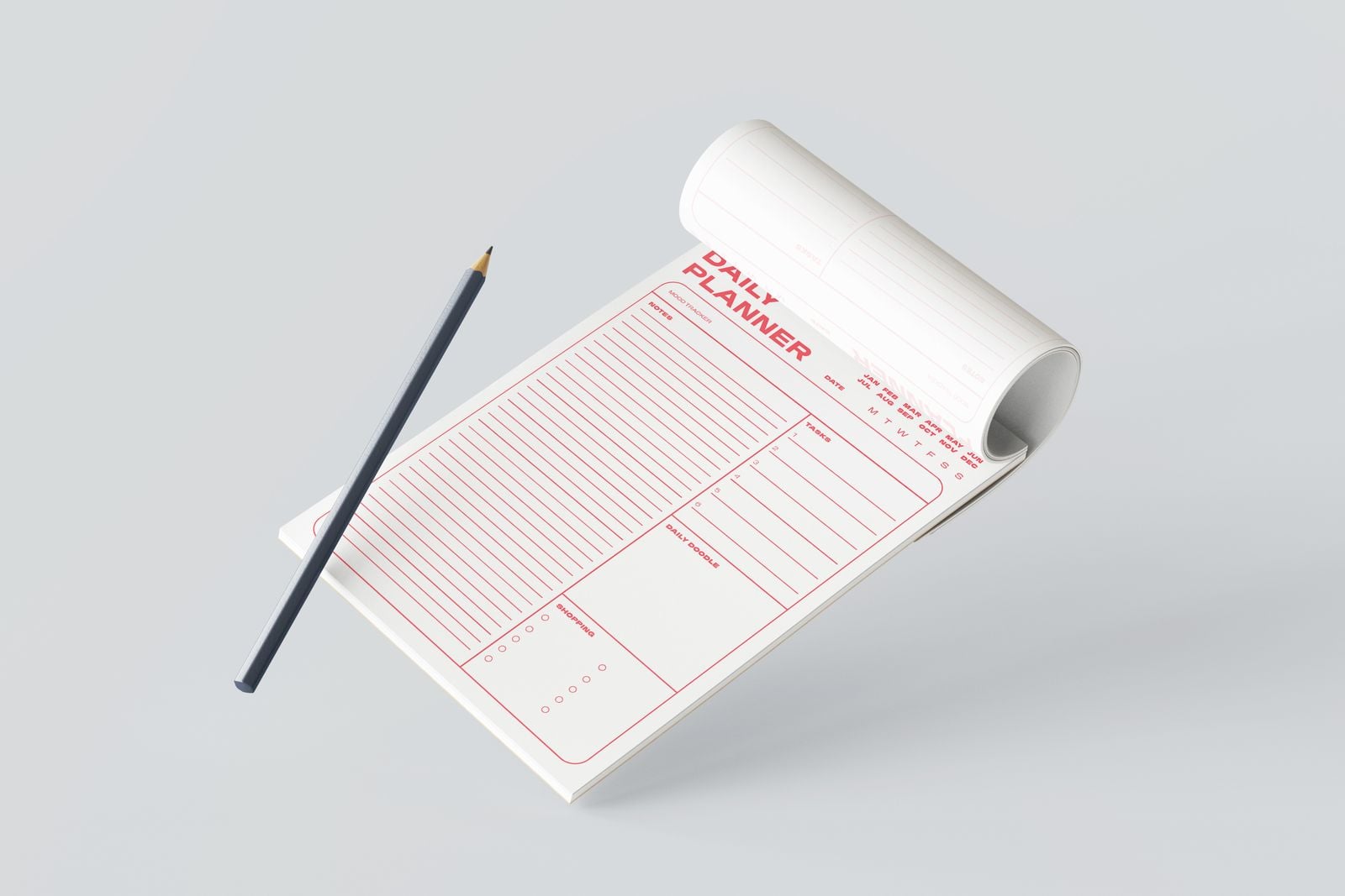 Daily planner notepad with its top sheet curled back and a pencil