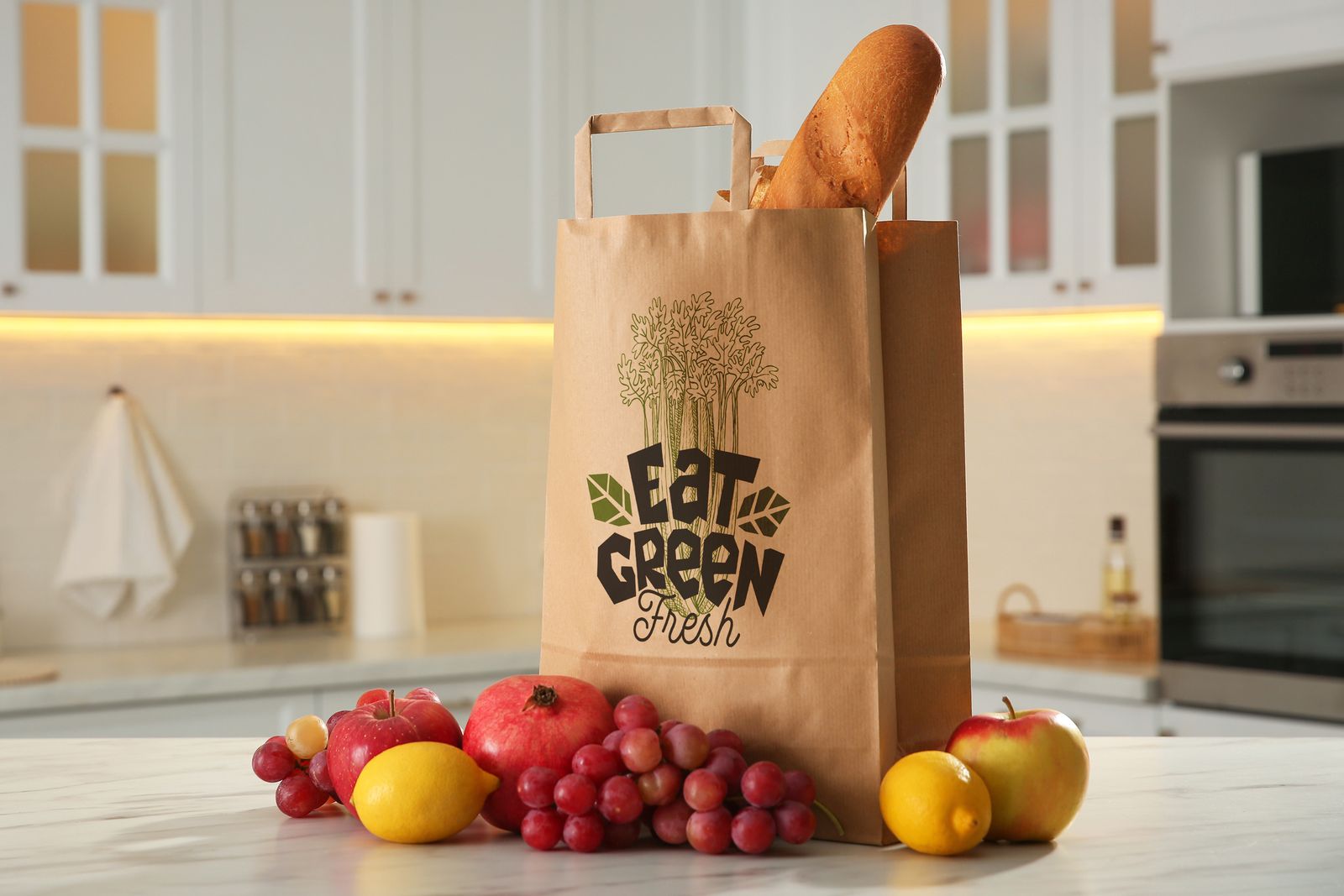 Brown kraft flat handle bag for a greengrocer, with bread and fruit on a kitchen counter