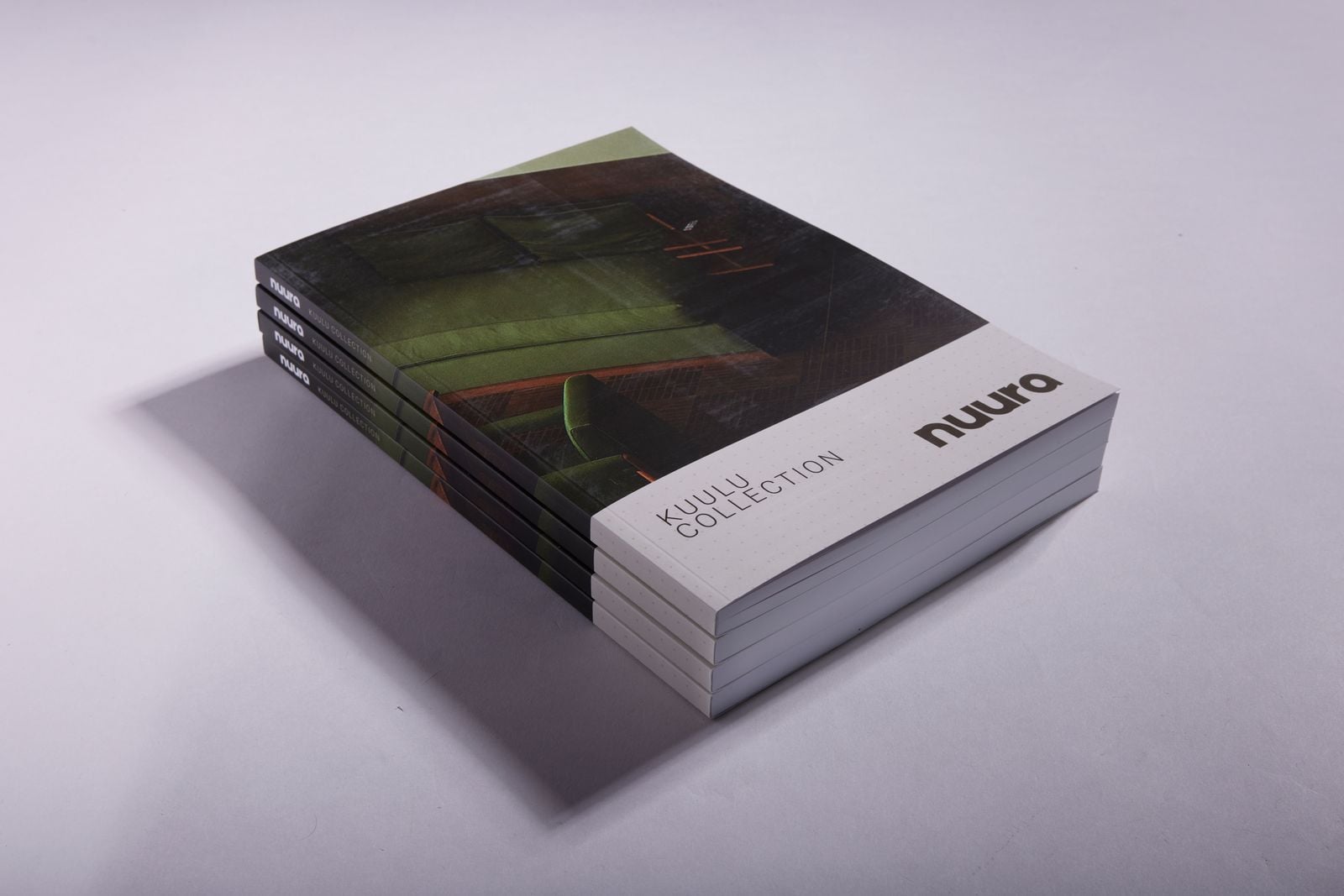 Stack of perfect bound furniture catalogues showing their square glued spines