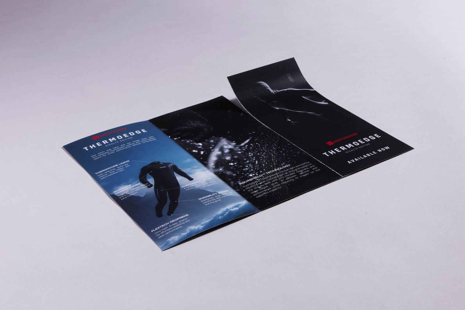 Opened DL wetsuit leaflet with a perforated tear-off panel peeling away at one end