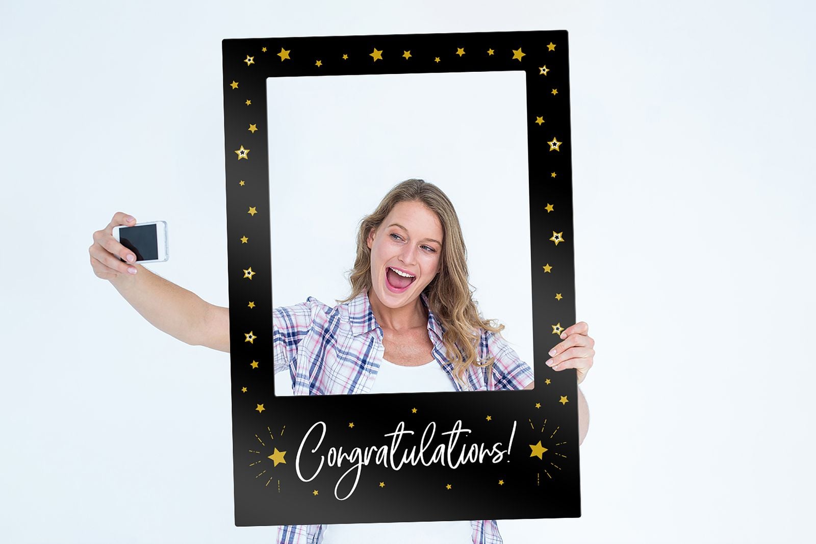 Woman taking a selfie through a black “Congratulations!” photo frame