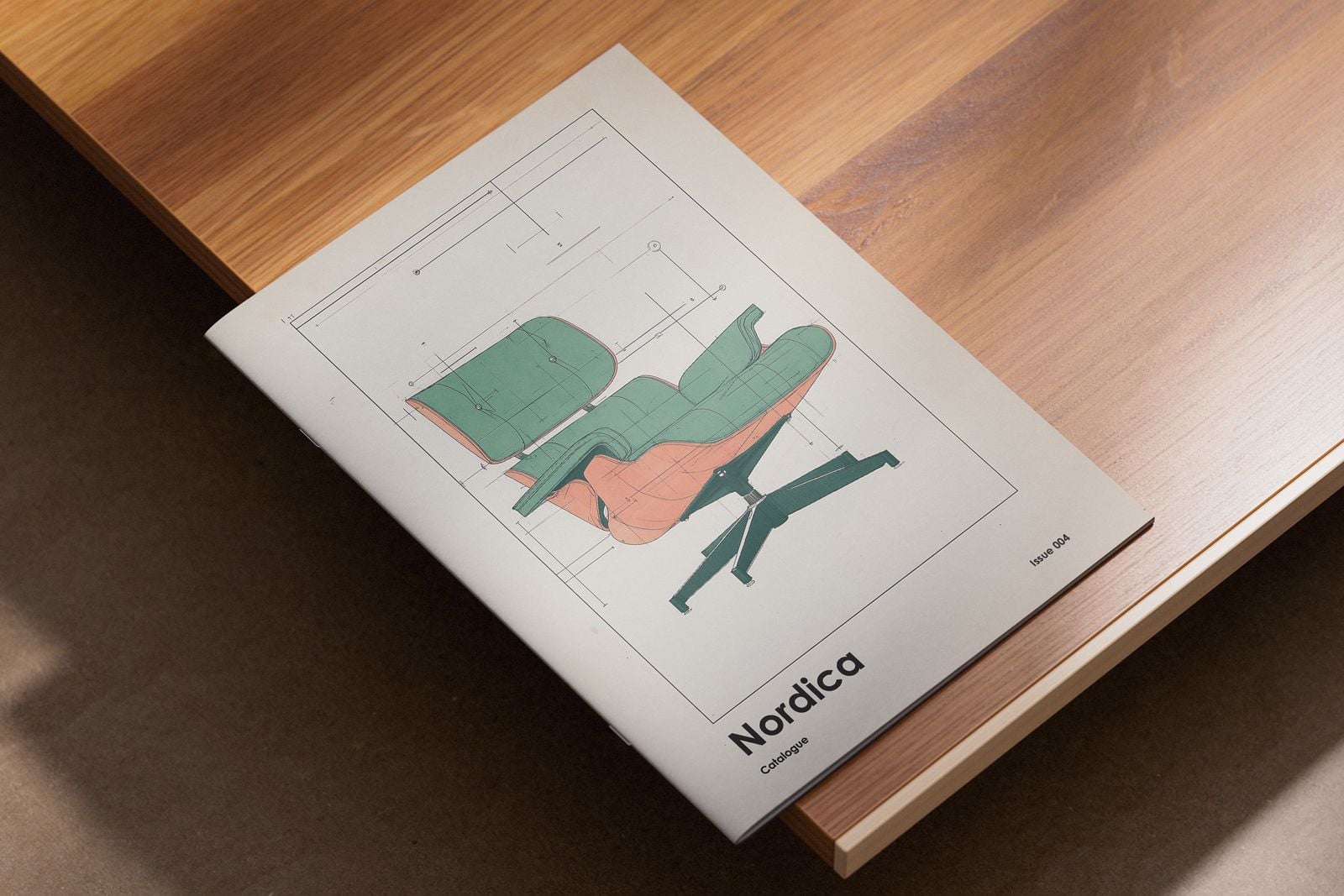 Furniture catalogue booklet with a chair illustration on the cover, on a wooden table