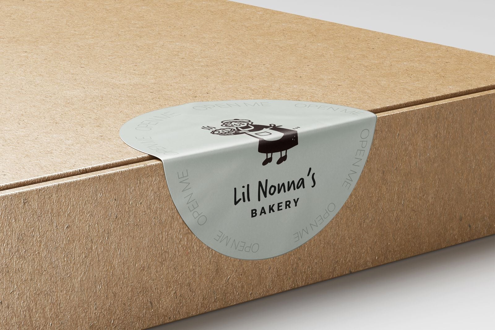 Round bakery sticker sealing a kraft box