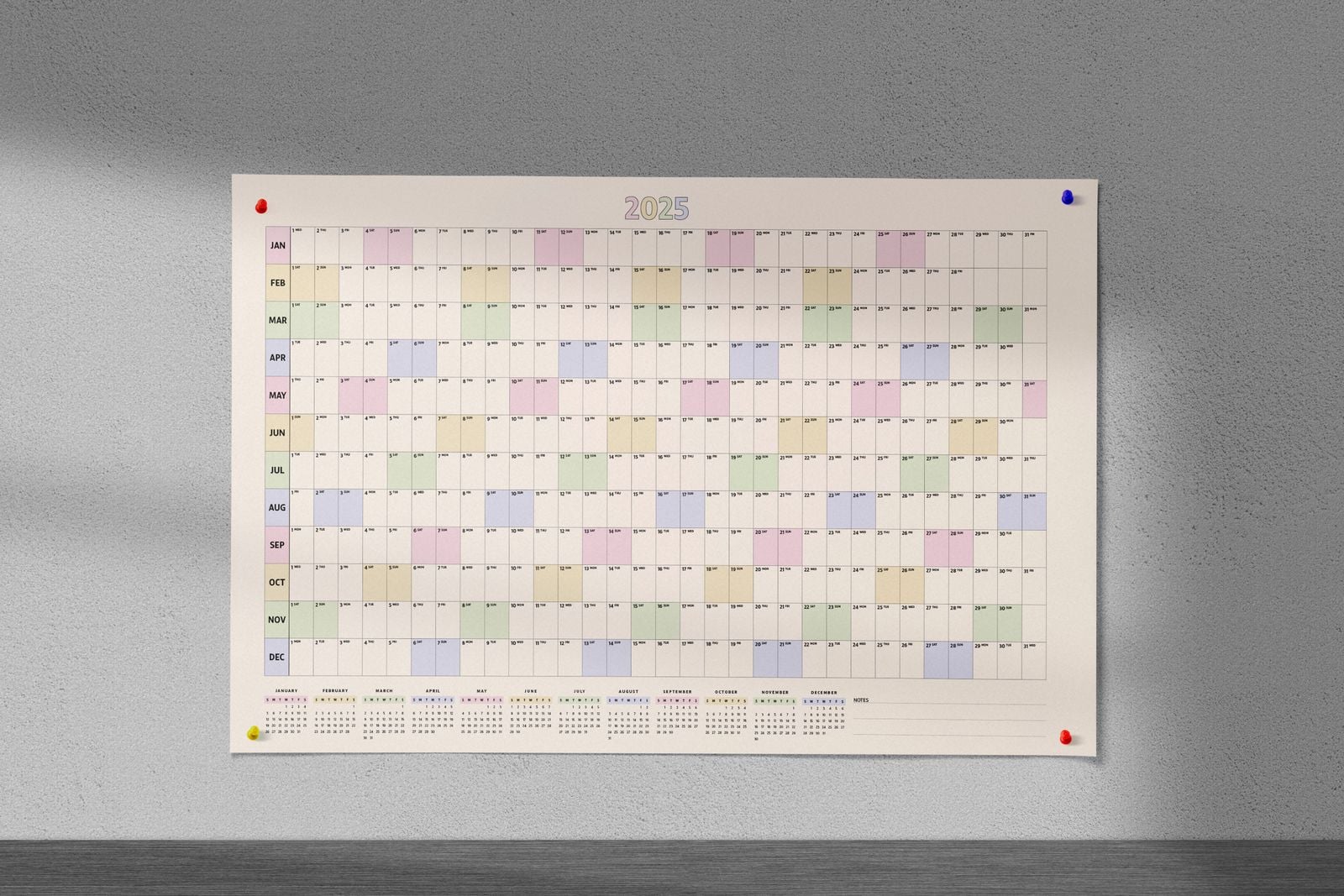 Pastel year wall planner pinned to a grey wall