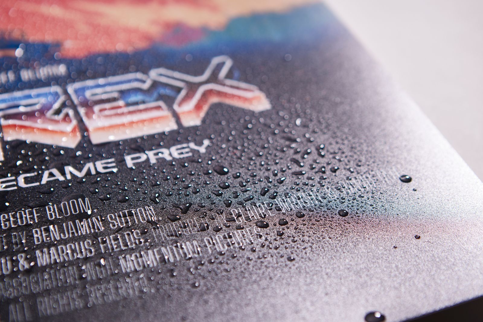 Water droplets beading on the printed surface of a waterproof poster