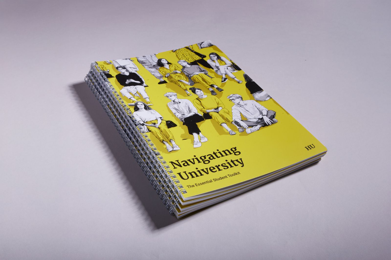 Stack of yellow wiro bound university guides