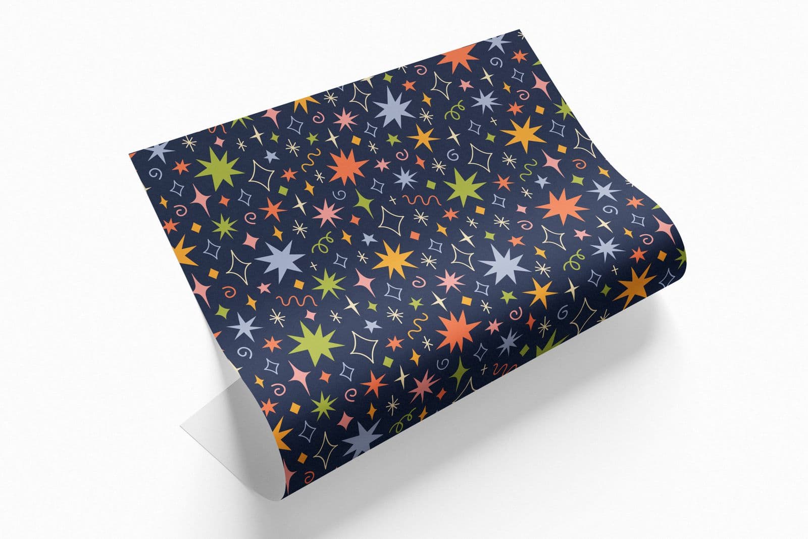 Sheet of navy wrapping paper with colourful stars, curling at one end
